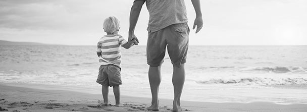 father and young son on beach